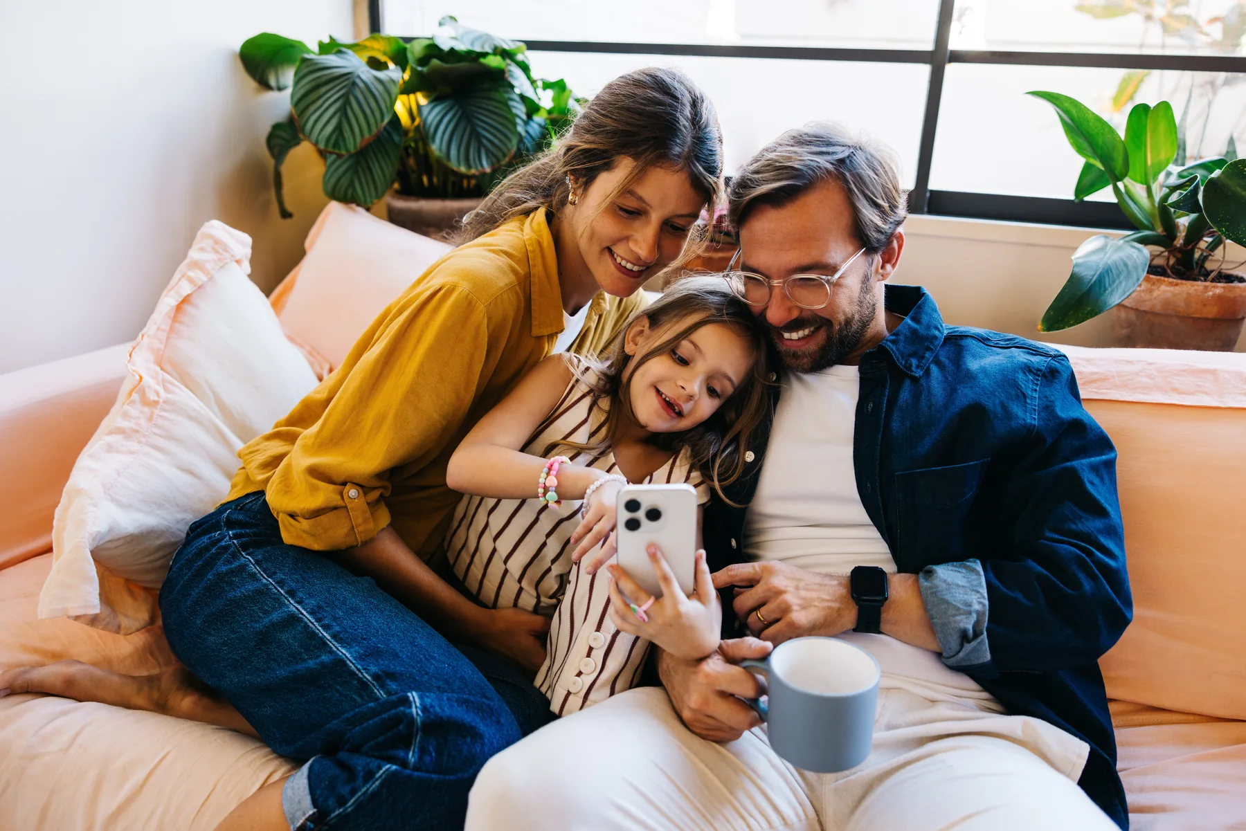 Smiling Family with Dog Smiling family sitting on a couch with a dog