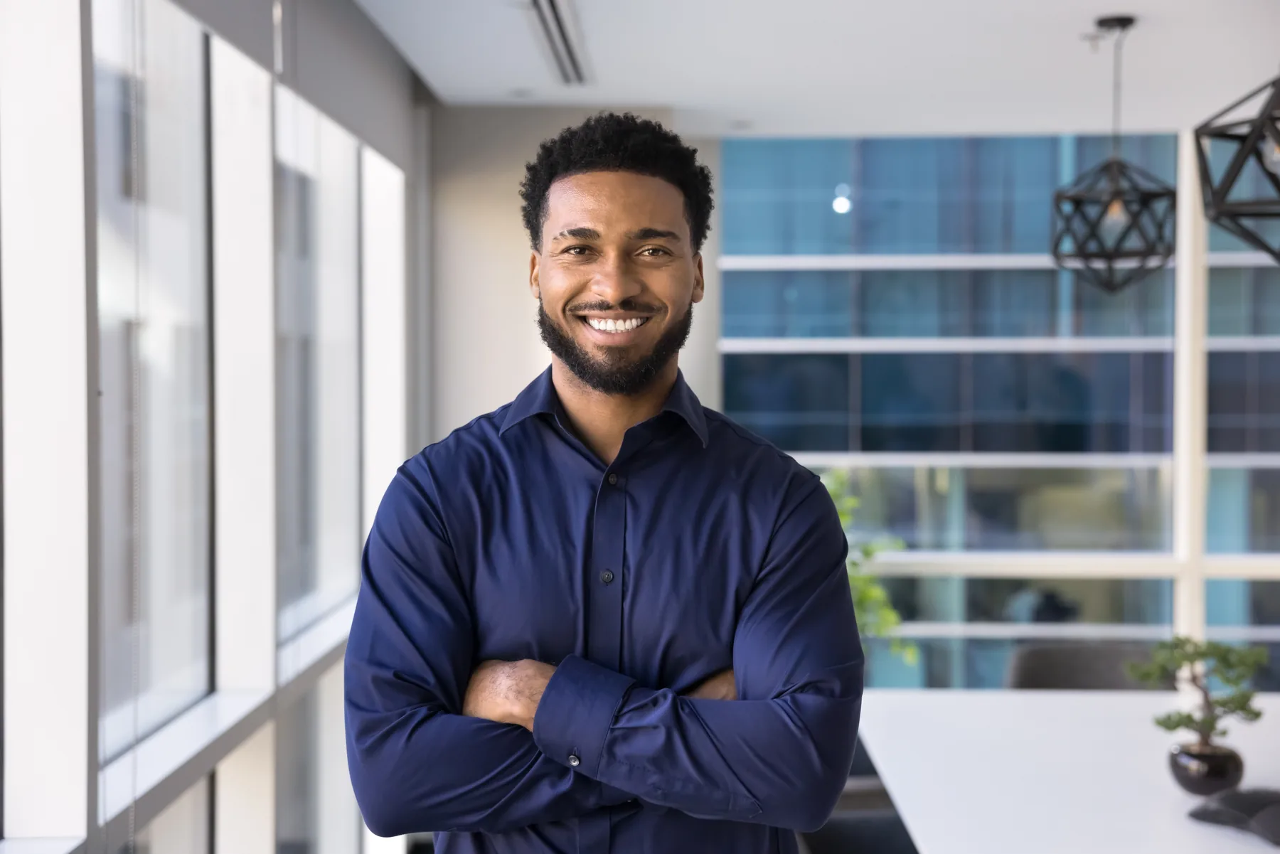 Smiling Man in Office Smiling man standing in a modern office