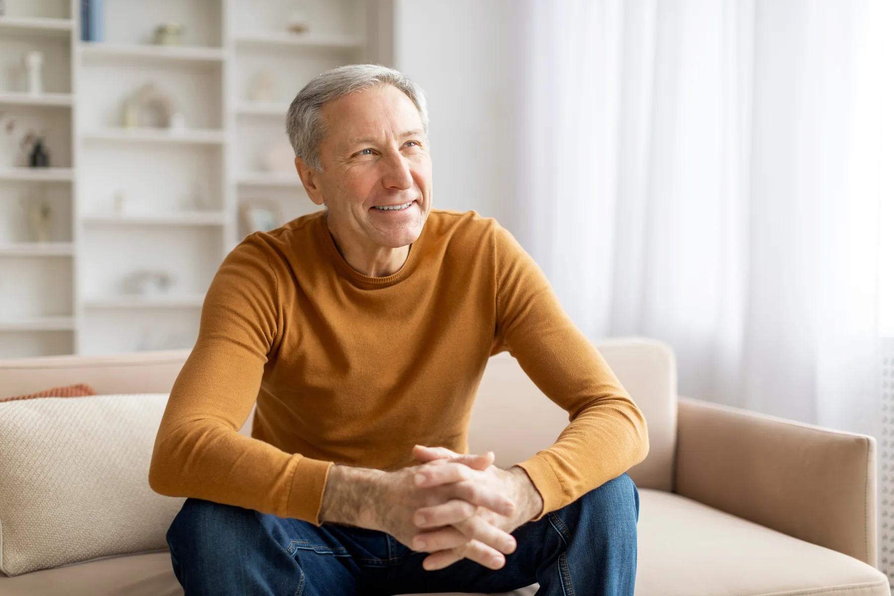 Smiling Senior Man on Couch Smiling senior man sitting on a couch